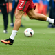 Moths fly around as Portugal's Cristiano Ronaldo runs during warm up before the Euro 2016 final soccer match between Portugal and France at the Stade de France in Saint-Denis, north of Paris, Sunday, July 10, 2016. (AP Photo/Martin Meissner)